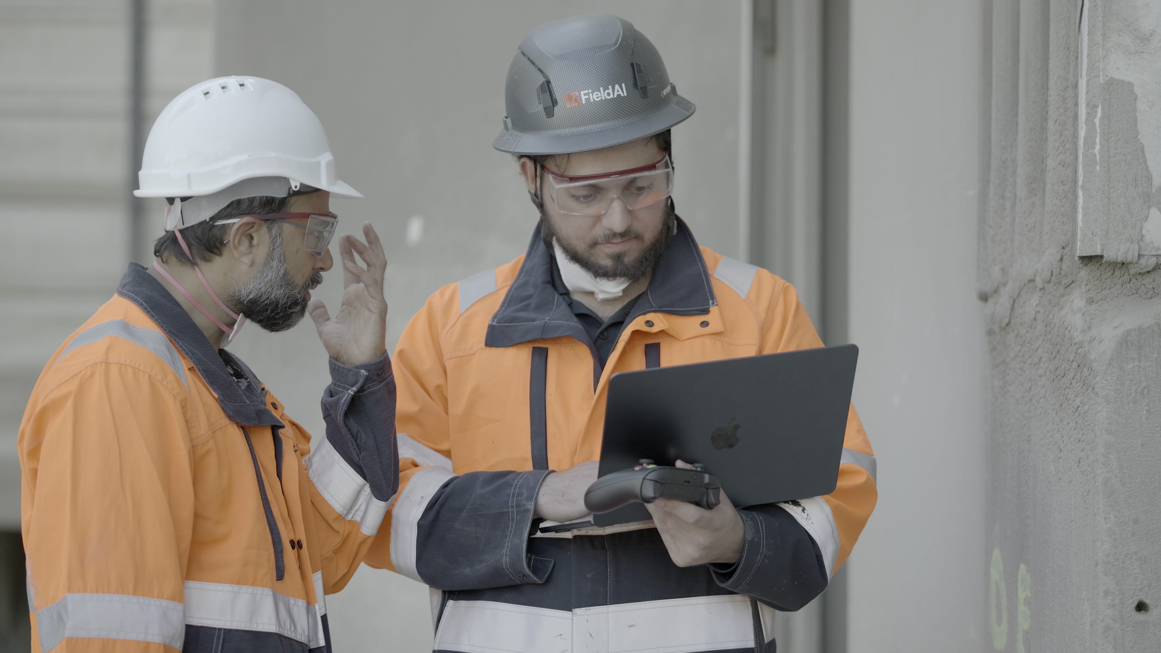 Field AI engineers reviewing the robot’s software at Holcim