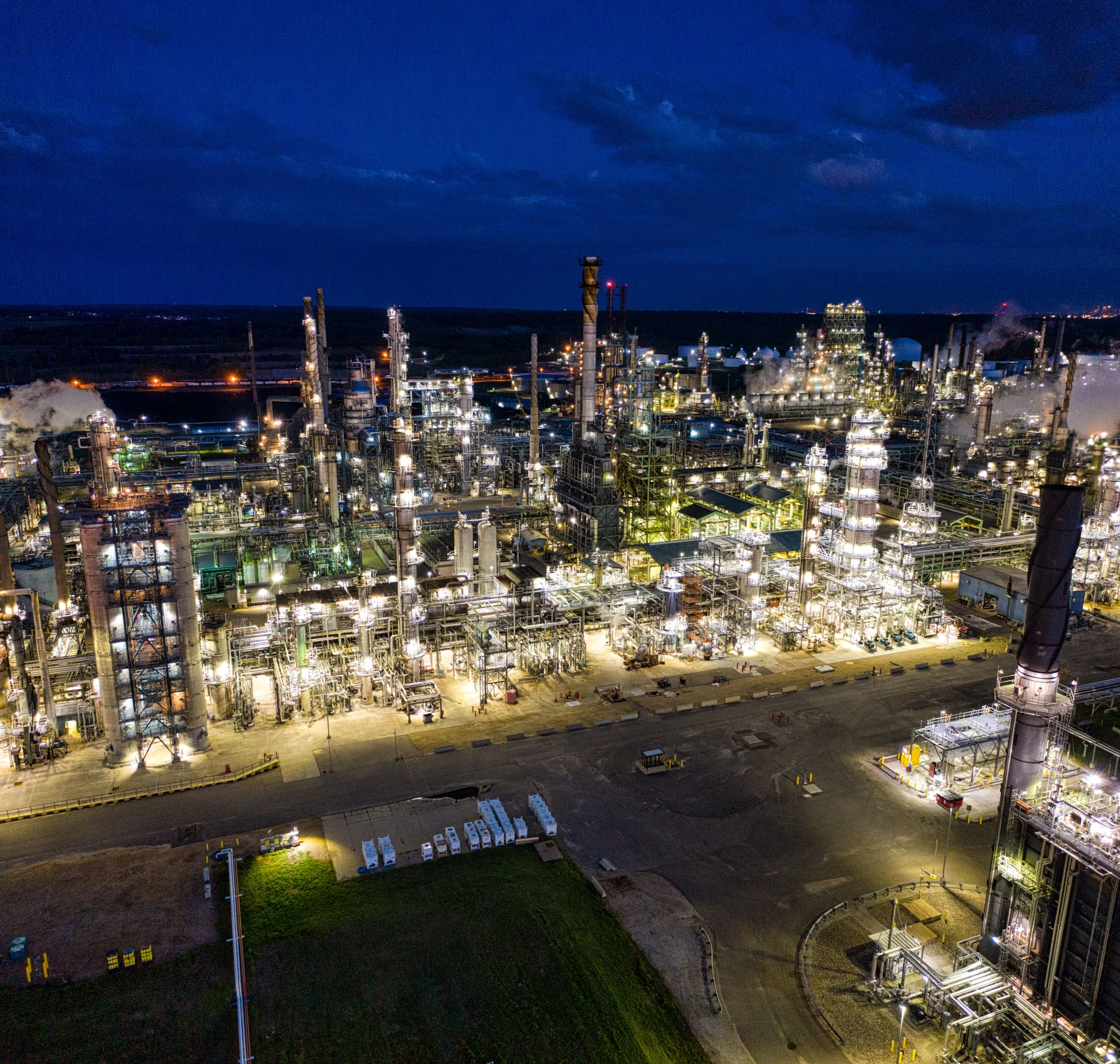 Illuminated process units and pipework at a refinery at night